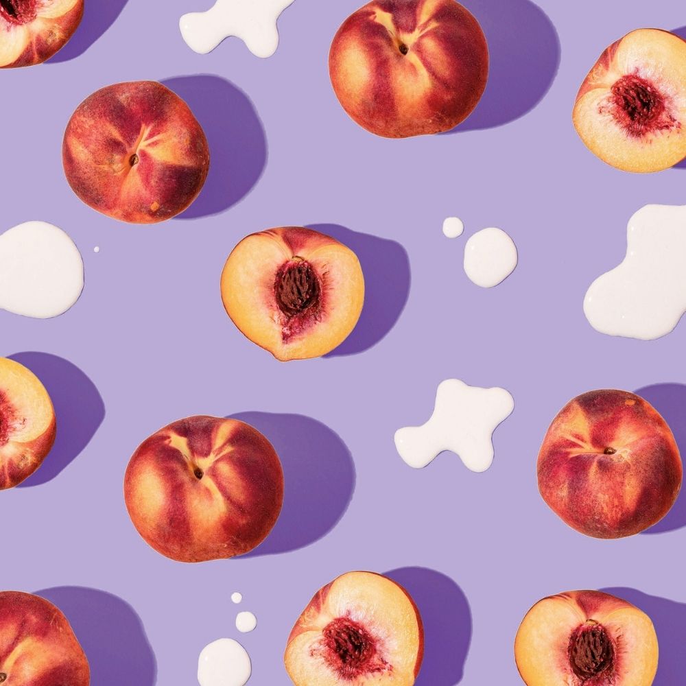 Pattern of peaches and white splashes shapes on a purple background