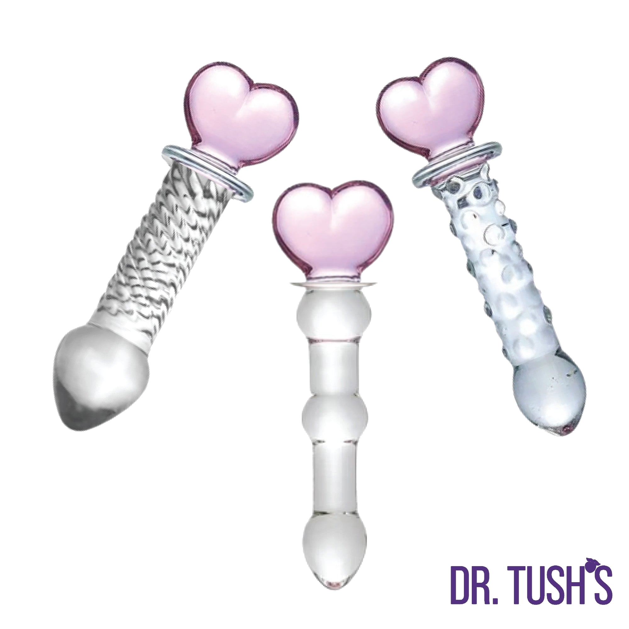 Three glass butt plugs with pink heart shaped top and glass dildo with and clear design on a white background, branded 'Dr. Tush'.
