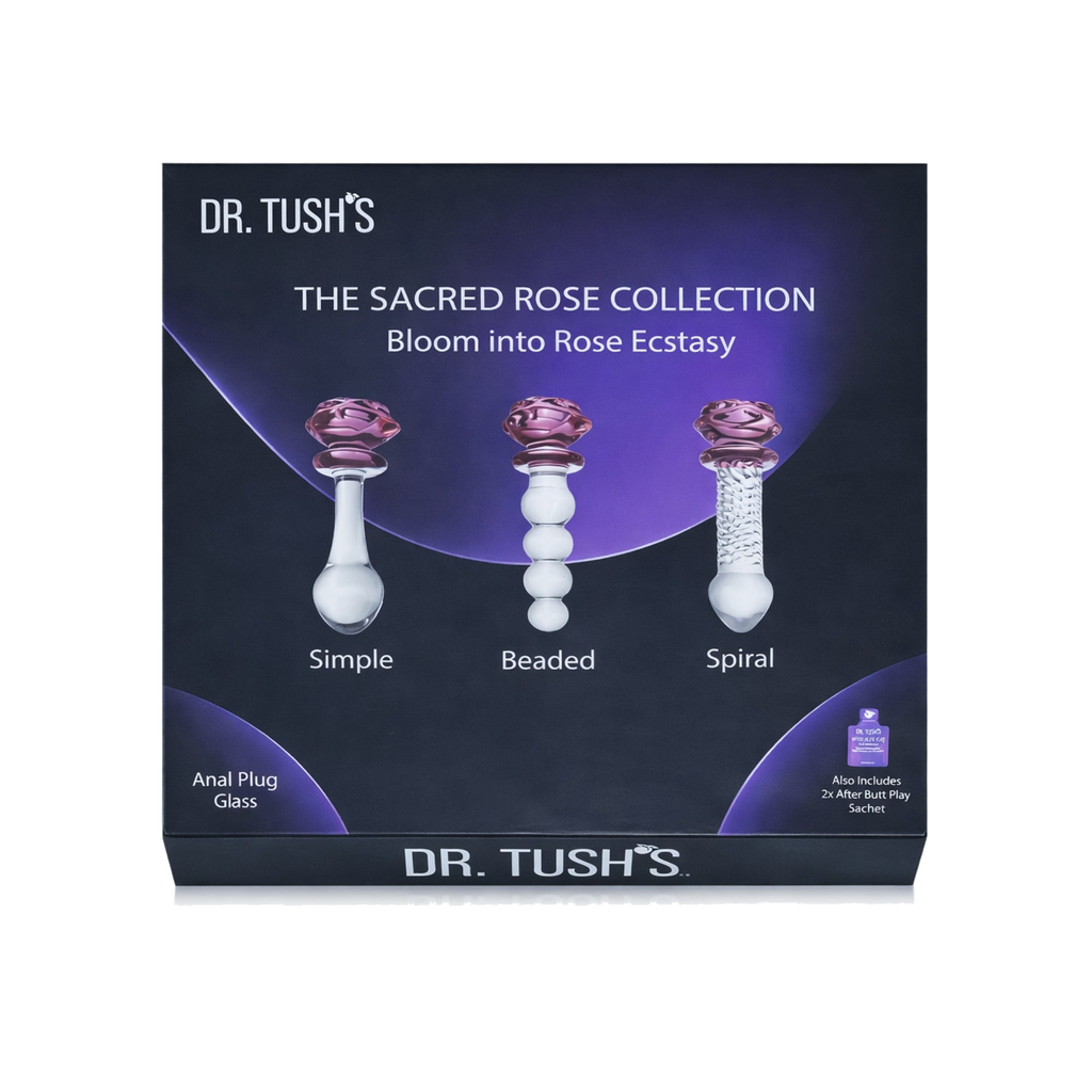 Dr. Tush's The Sacred Rose Collection packaging with Three glass butt plugs and glass dildo with purple rose top and clear design on a white background, branded 'Dr. Tush'. on a dark background.